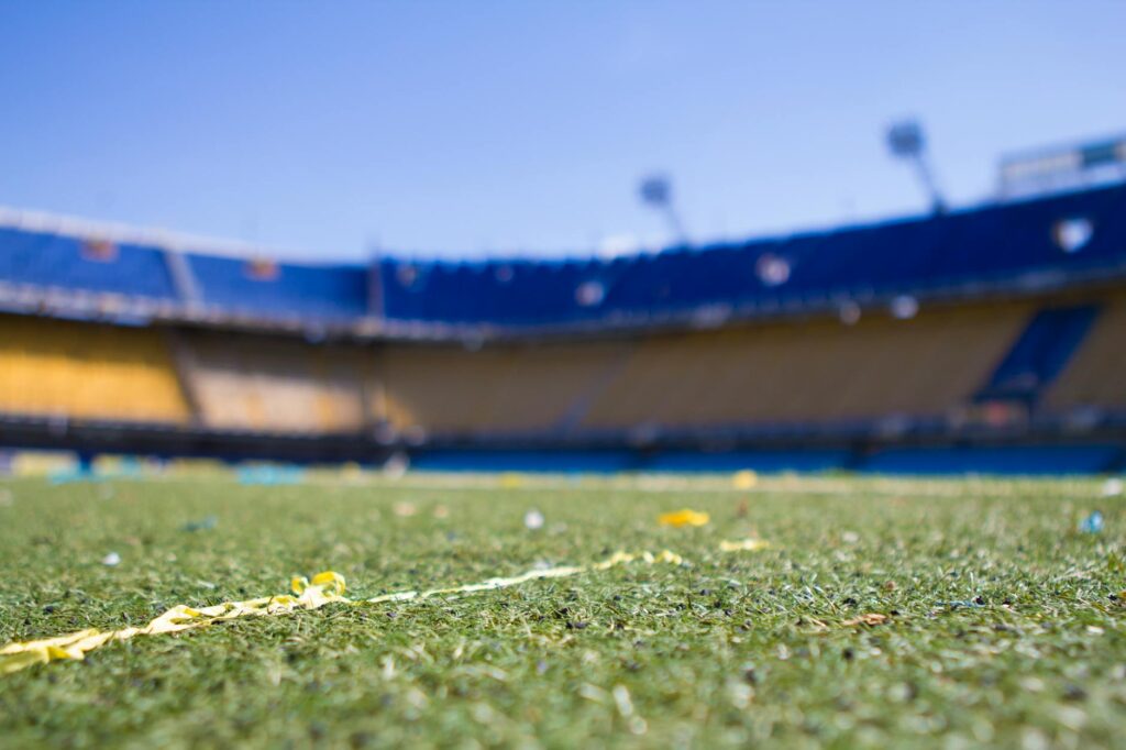 Close-up view of a vibrant football pitch in a sunlit Buenos Aires stadium, perfect for sports enthusiasts.